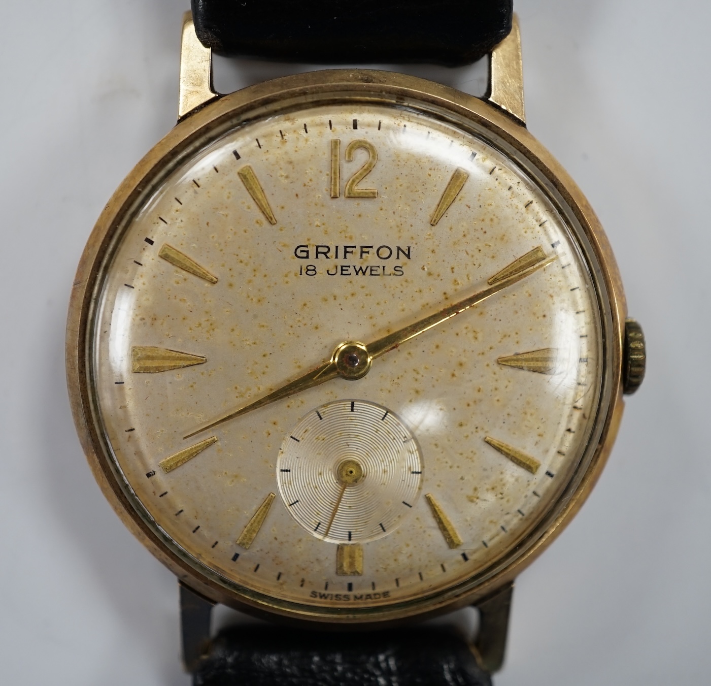 A gentleman's Swiss 9ct gold Griffon manual wind wrist watch, on a leather strap, case diameter 33mm.